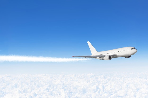 Passenger airplane flying at flight level high in the sky above the clouds