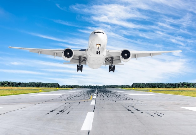 Passenger airplane landing at in good clear weather with a blue sky on a runway