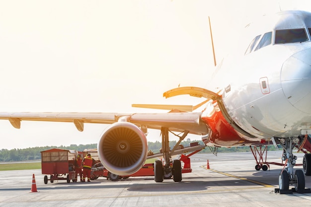 Passenger airplane stand by for loading luggage and move to conveyor at the international airport concpept flight transport by air