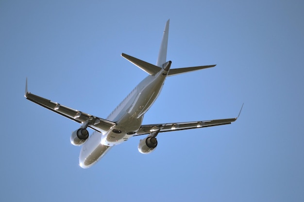 Passenger jet plane flying view from below