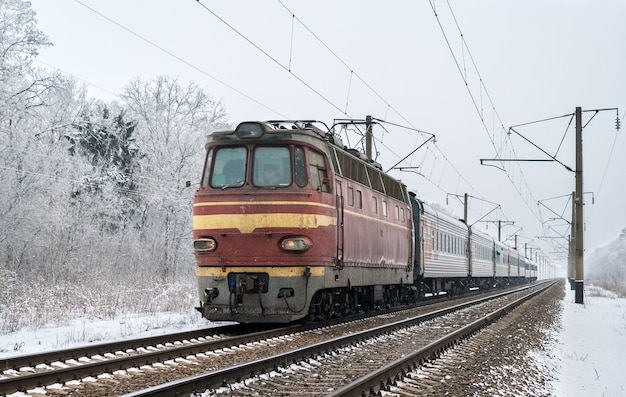 Passenger train hauled by electric locomotive in Ukraine