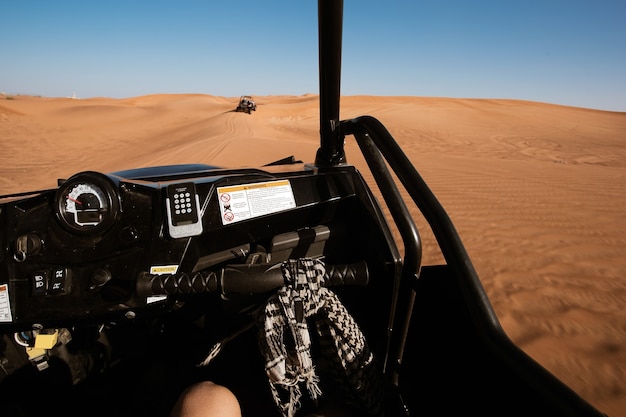 Passenger view from buggy quad bike driving at Dubai desert safari tour