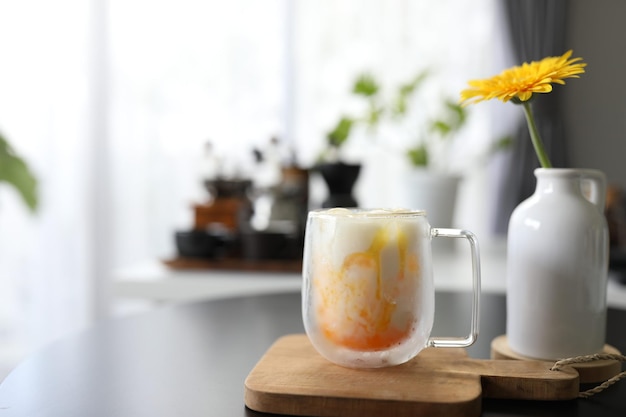 Passion fruit in glass cup and a vase of Yellow gerbera