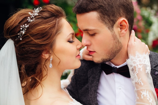 The passion between the magnificent bride and the elegant groom who are want to kiss