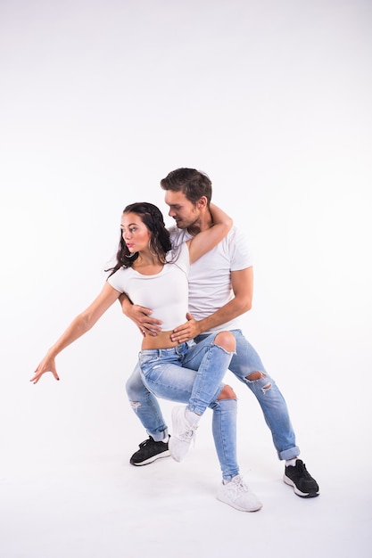 Passionate couple dancing social danse kizomba or bachata or semba or taraxia on white background