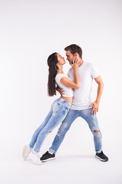 Passionate couple dancing social danse kizomba or bachata or semba or taraxia on white background