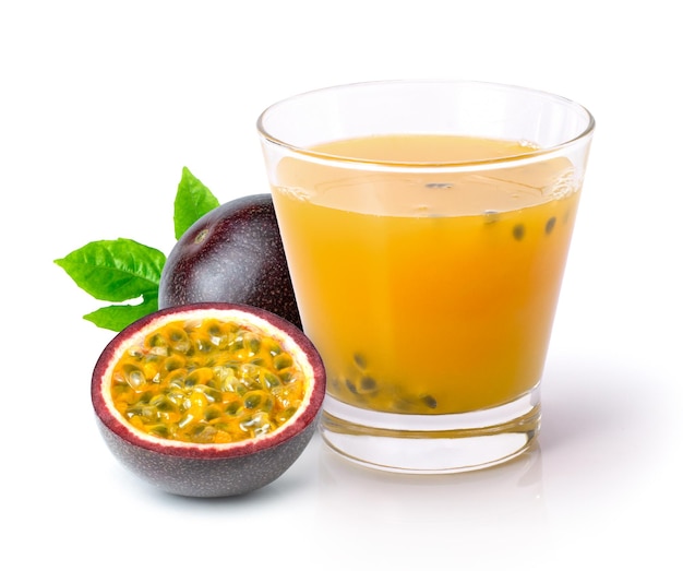 Passionfruit juice in glass and fresh passion fruit with green leaf isolated on white background