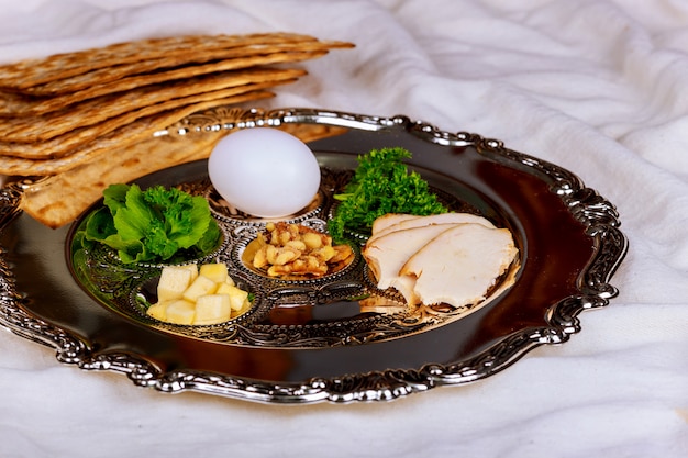 Passover background with wine bottle, matzoh, egg and seder plate