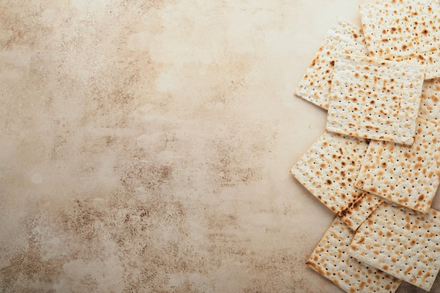 Passover celebration concept Matzah red kosher and walnut Traditional ritual Jewish bread on sand color old concrete background Passover food Pesach Jewish holiday