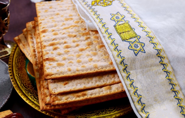 Passover matzoh jewish holiday bread over wooden table.