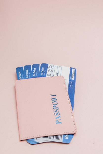 Passport and air ticket on pink. Travel concept, copy space.