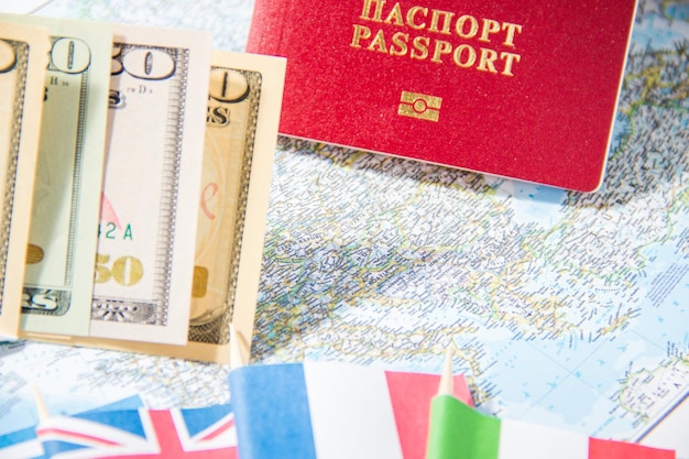 Passport magnifier red toy car and money on map Budget planning concept