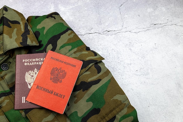 Passport military ID on a military uniform and a citizen of the Russian Federation Text in Russian PASSPORT OF THE RUSSIAN FEDERATION and MILITARY ID