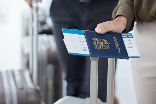 Passport travel and airport with the hand of a passenger holding documents while waiting for a flight Immigration identity and boarding pass with a person holding a ticket leaving for a holiday