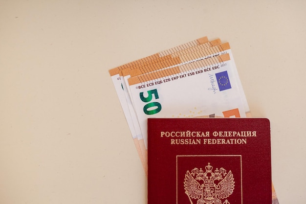 A passport with a red passport and a euro banknote