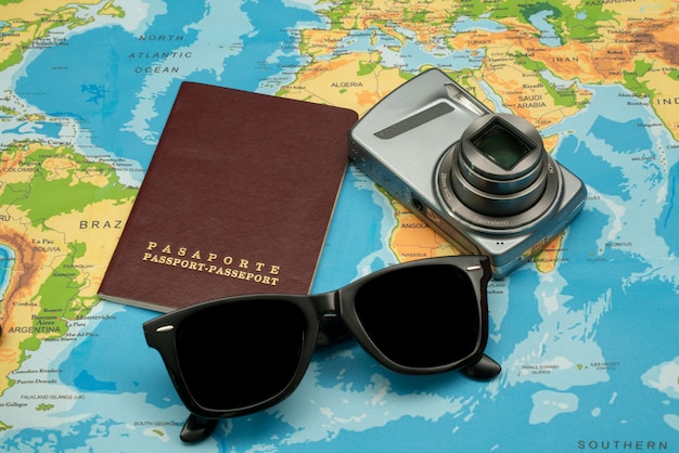 Passport, world map, glasses, camera. Travel concept