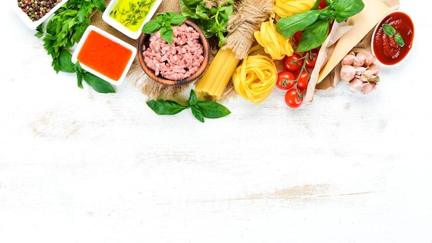 Pasta Bolognese and Ingredients On a white wooden background Top view Free space for your text