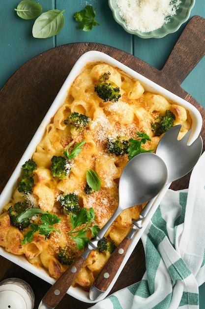 Pasta Broccoli casserole Baked Mac and cheese with broccoli cream sauce and parmesan on old rustic wooden background Healthy or baby food American Casserole Top view Copy space