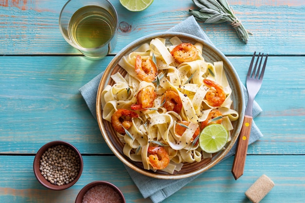 Pasta fettuccine in a creamy sauce with shrimp lime and sage Italian food