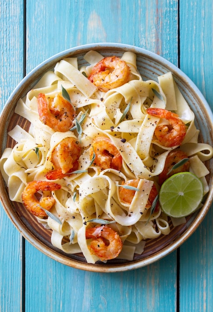 Pasta fettuccine in a creamy sauce with shrimp lime and sage Italian food