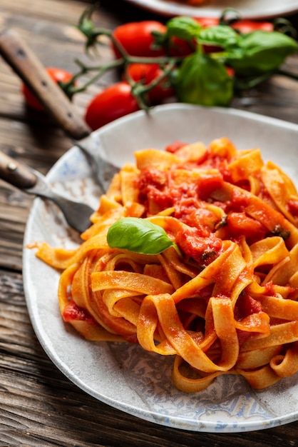 Pasta fettuccine with tomato and basil