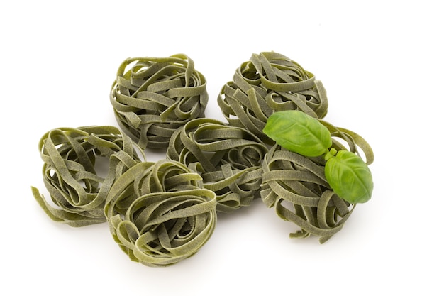 Pasta; food; spinach; cooking; cuisine; curve; dried; dry; eating; egg; fettuccine; flour; gourmet; green; ingredient; italian; nest; raw; vegetarian; wheat;