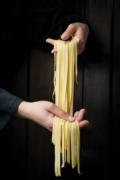 Pasta in hands. homemade pasta.