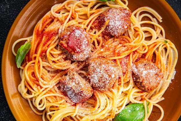 pasta meatball spaghetti tomato sauce grated parmesan cheese dish meal food snack on the table