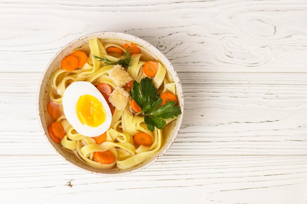 pasta noodle soup on wooden table