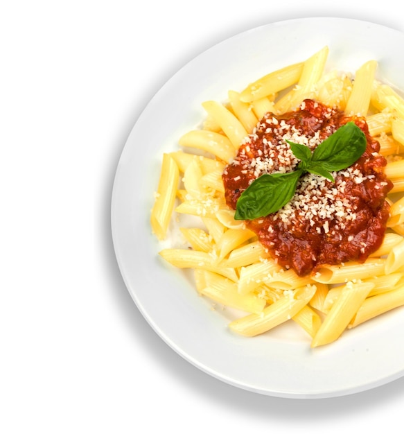 Photo pasta. penne pasta with bolognese sauce, parmesan cheese and basil on a fork. italian cuisine.