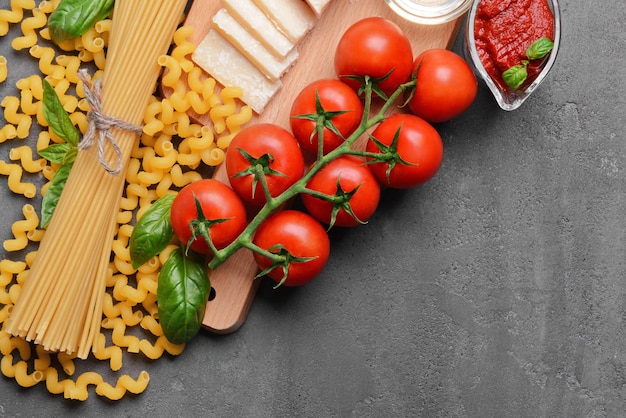 Pasta and products on color background