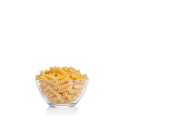 Pasta products in the form of a spiral on a plate texture on a white background