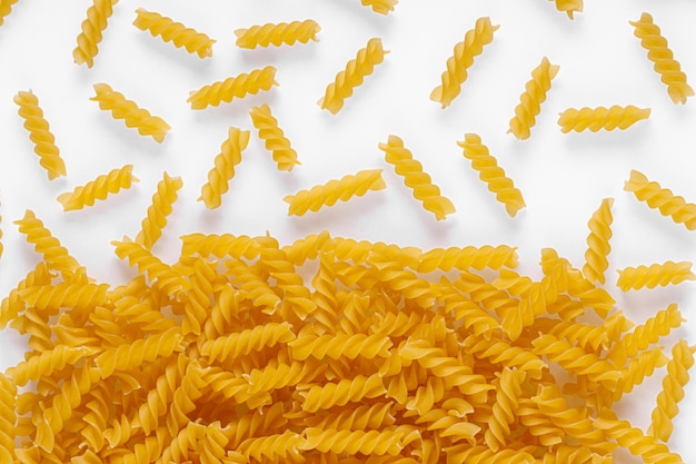 Pasta products in the form of a spiral texture on a white background