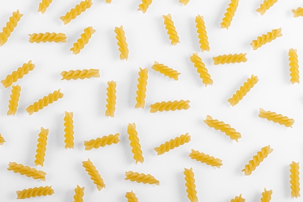 Pasta products in the form of a spiral texture on a white background