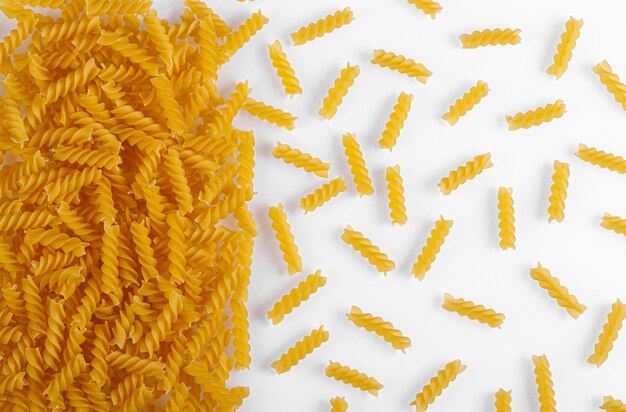 Pasta products in the form of a spiral texture on a white background