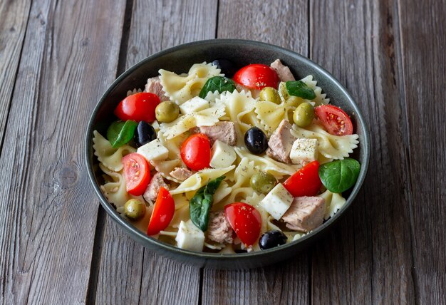 Pasta salad with tuna, tomatoes and white cheese. Farfalle. Healthy eating. Diet.