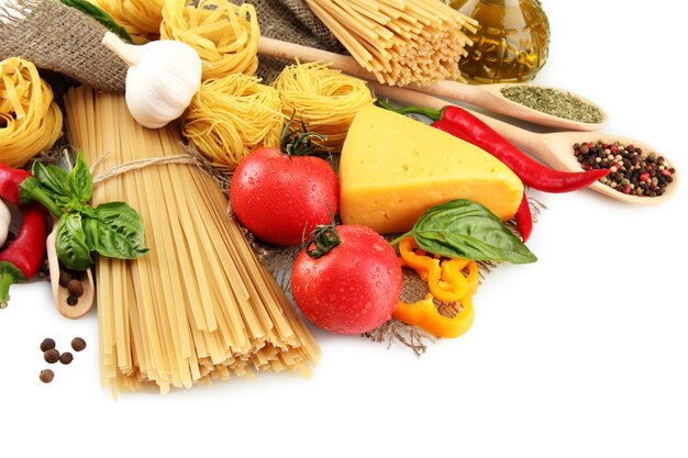 Pasta spaghetti vegetables and spices isolated on white