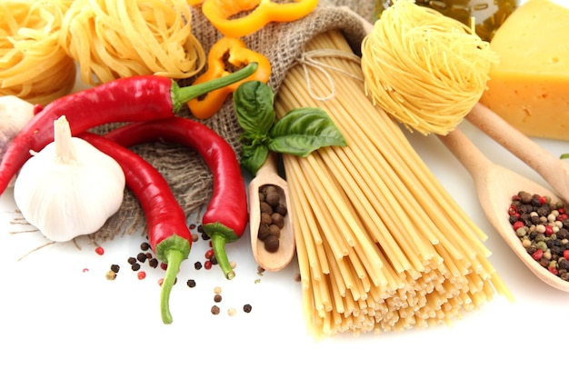 Pasta spaghetti vegetables and spices isolated on white