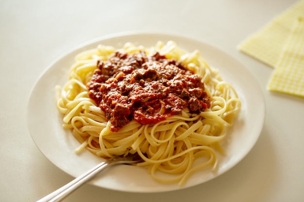 Pasta spaghetti with ragu sauce  on white plate