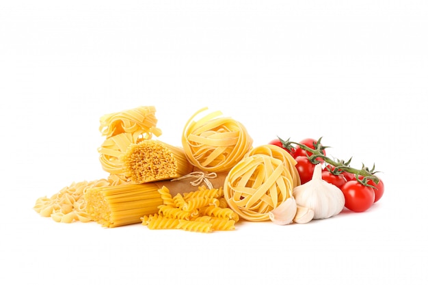 Pasta and vegetables isolated on white. Uncooked whole wheat pasta