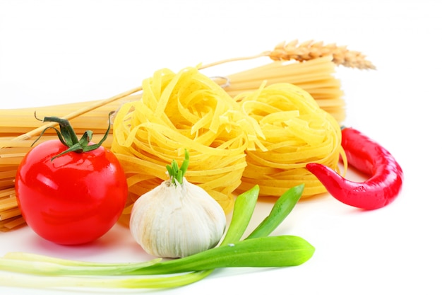 Pasta on a white background in a composition with accessories for the kitchen