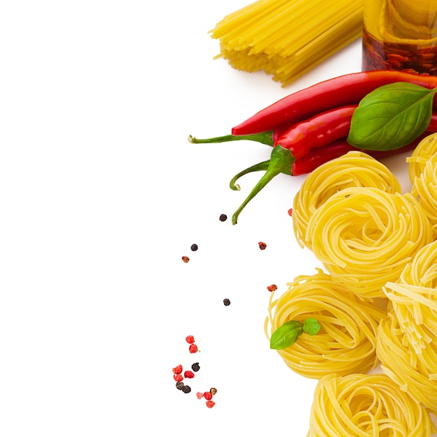 Pasta with basil chili pepper and spicy olive oil on white table