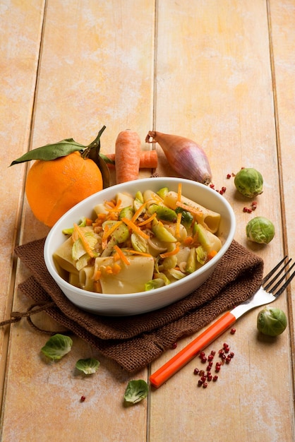 Pasta with brussel sprouts pink pepper and orange peel