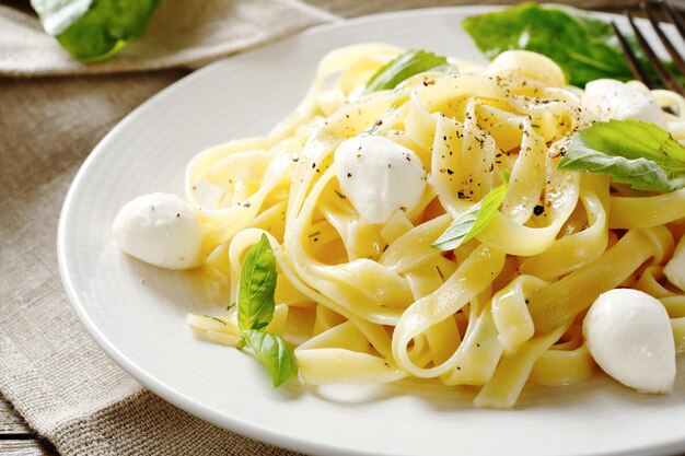 Pasta with cheese and basil on a plate food