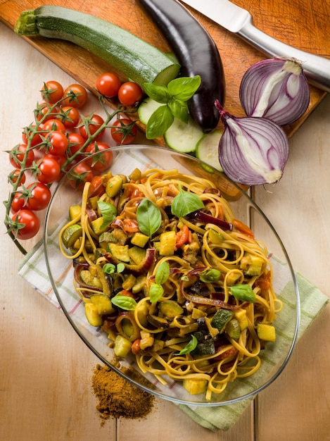 Pasta with eggplants zucchinis tomatoes and curry