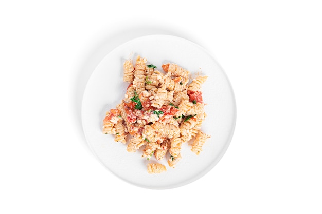 Pasta with feta cheese, tomatoes and herbs isolated.