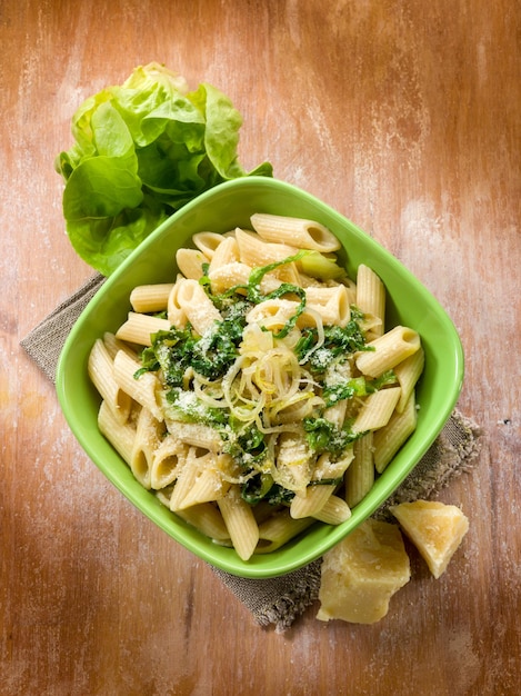 Pasta with lettuce parmesan cheese and onions vegetarian food