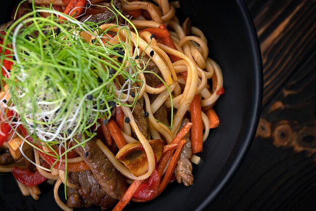 Pasta with meat mushrooms and vegetables with a small depth of field