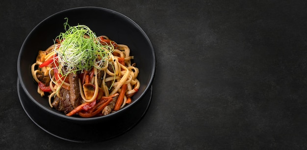 Pasta with meat mushrooms and vegetables with a small depth of field