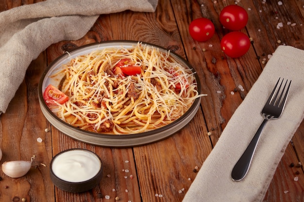 Pasta with meat and tomatoes, Italian cuisine, wooden background